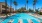 Swimming pool with lounge seating and umbrellas