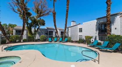 Swimming pool with lounge seating and umbrellas