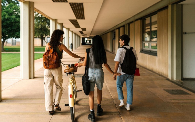 a group of people walking down a sidewalk
