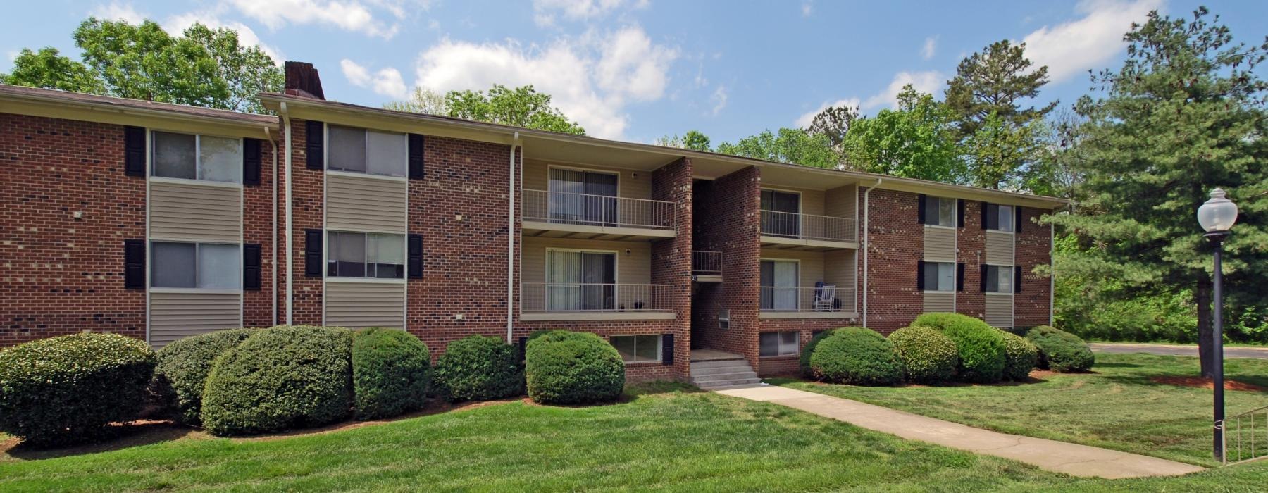 a building with a lawn and trees