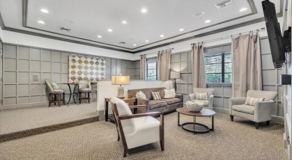 Resident movie room with tv and comfortable seating 