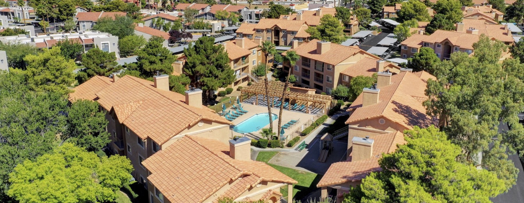 aerial view of a community with buildings and a courtyard with a pool
