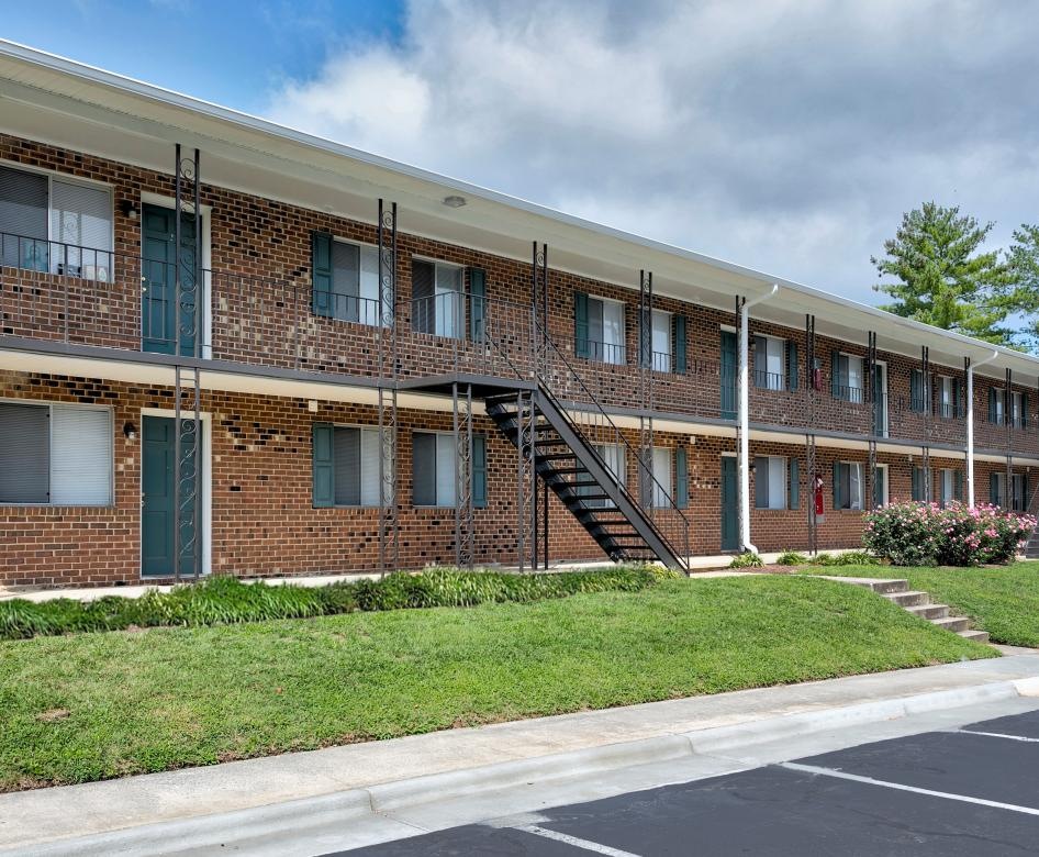 a building with stairs and grass