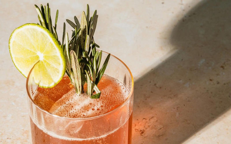a glass with a drink and a lemon on top