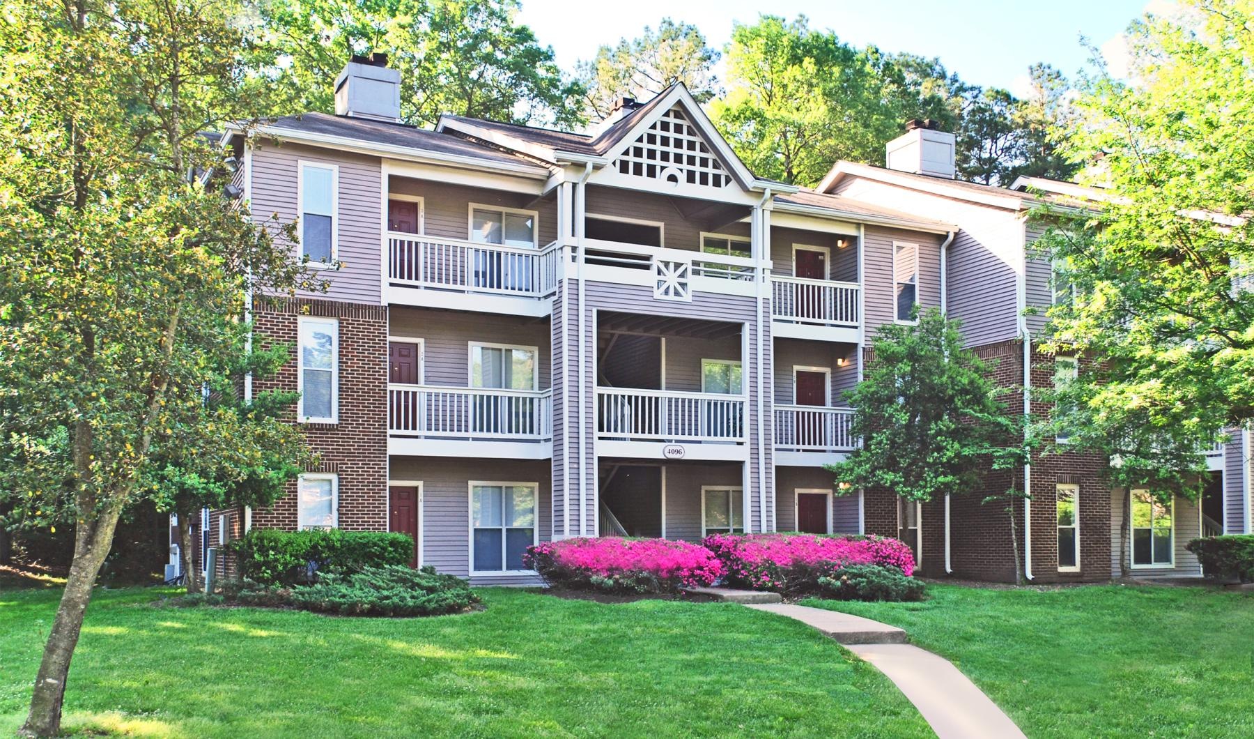 a large building with trees and grass