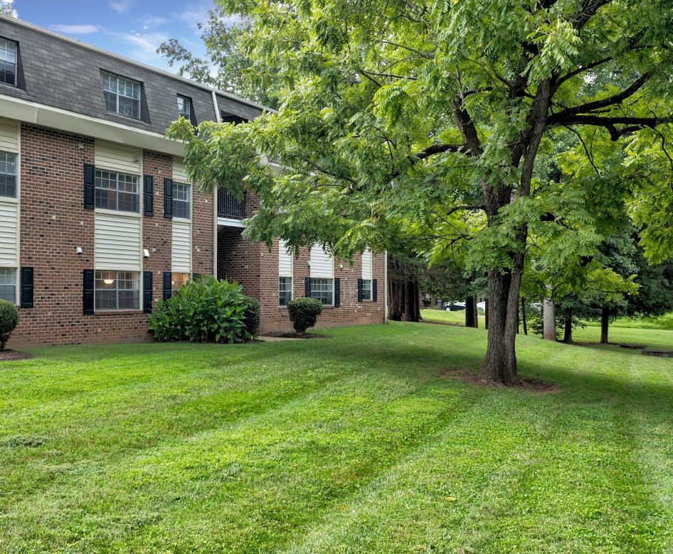 a brick building with trees in front