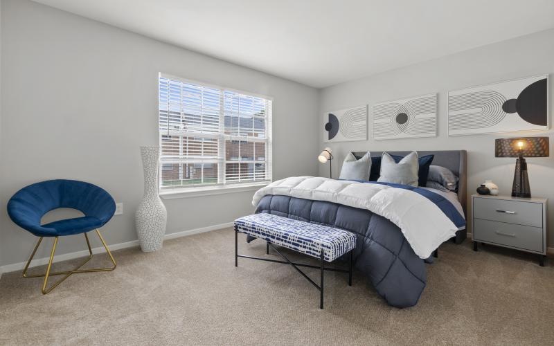 a bedroom with a bed and a chair