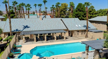 Swimming pool by the clubhouse with lots of palm trees