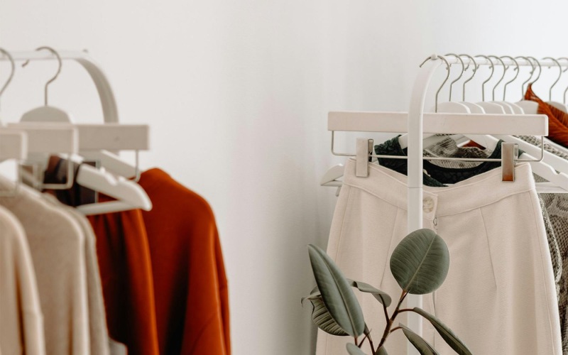 clothes on a rack near a plant