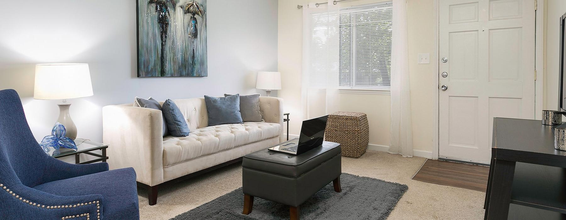 a living room with a laptop on a couch