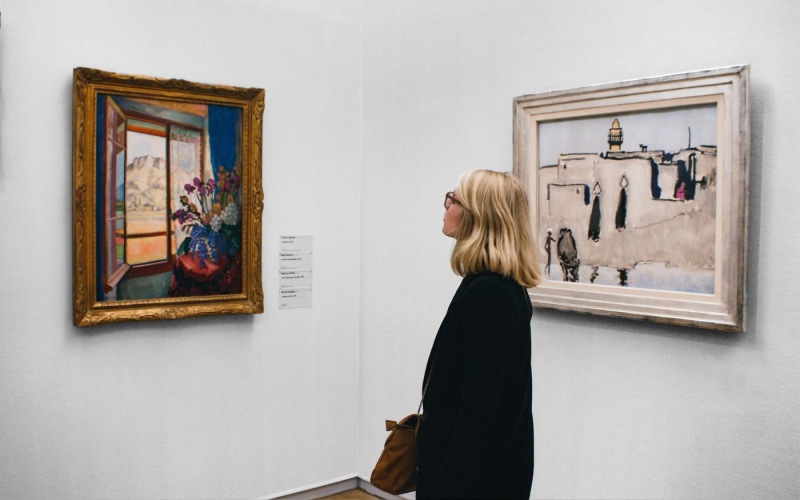 a person looking at art on the wall