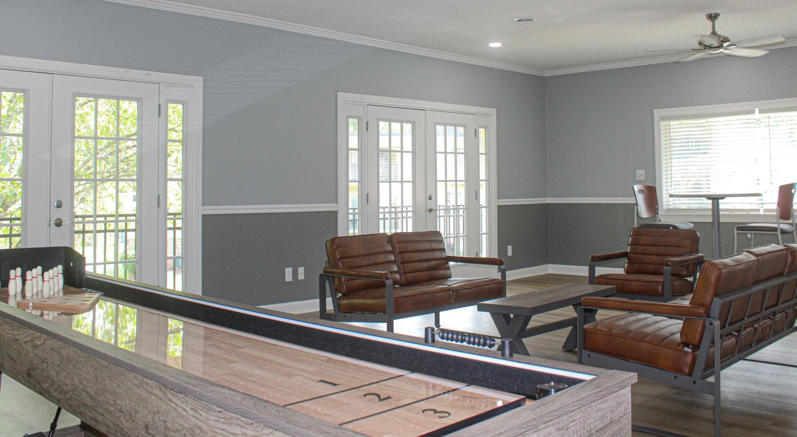 Clubhouse social seating area with shuffle board and kitchen