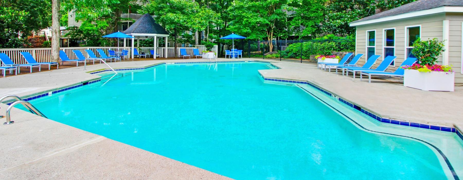 a swimming pool with chairs around it