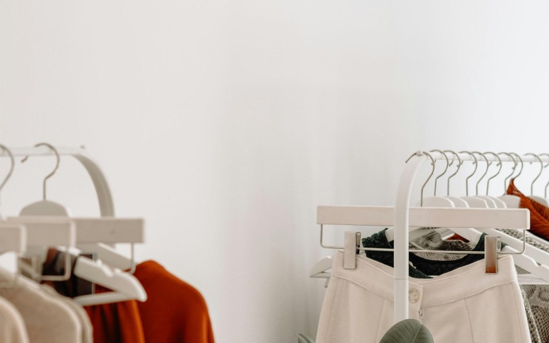 clothes on a rack near a plant