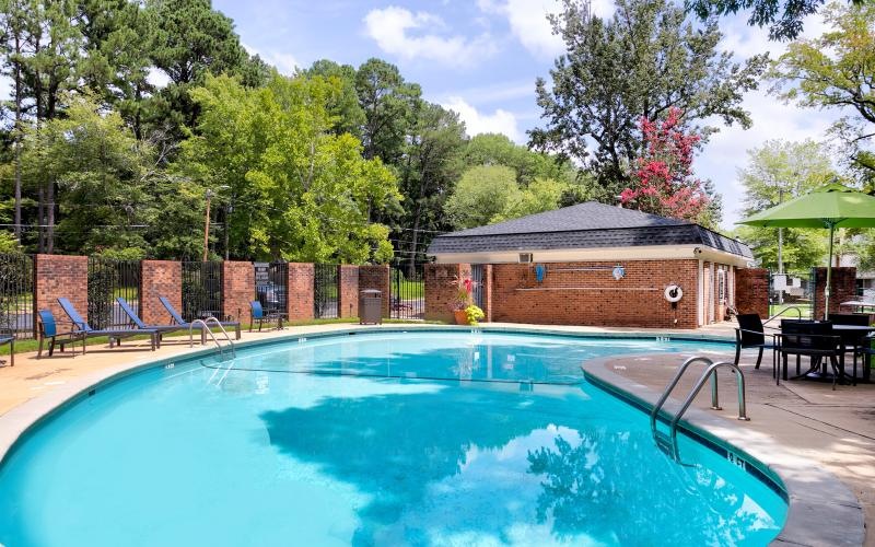 a swimming pool with a building in the background