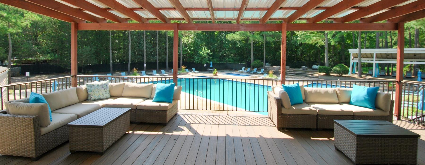 covered poolside patio with couches