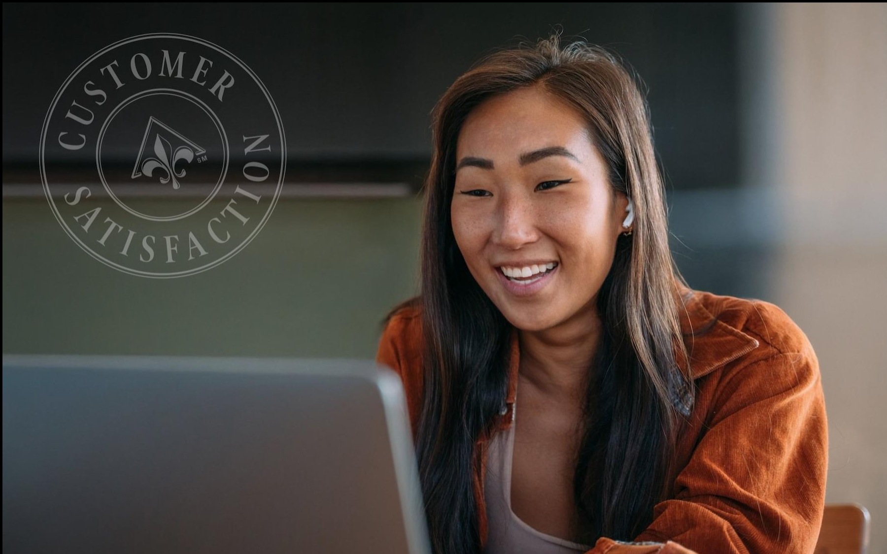 a woman smiling her laptop