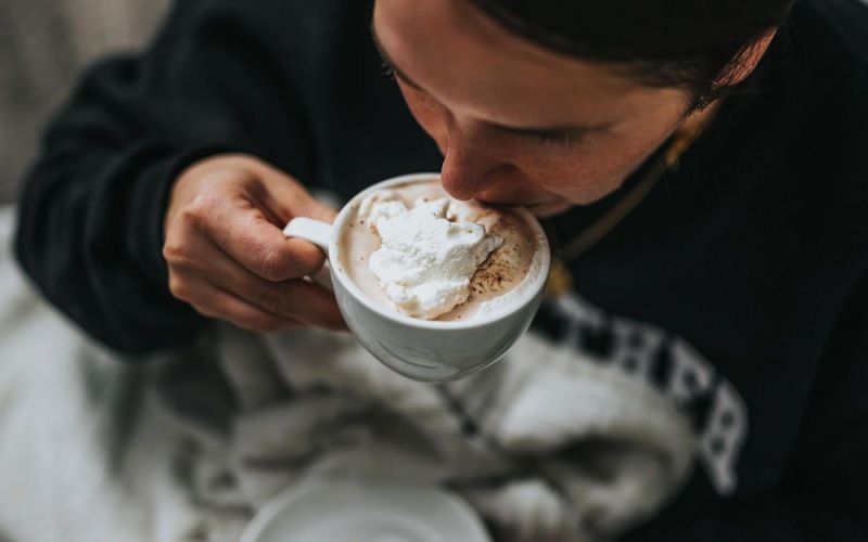 man sipping a hot beverage