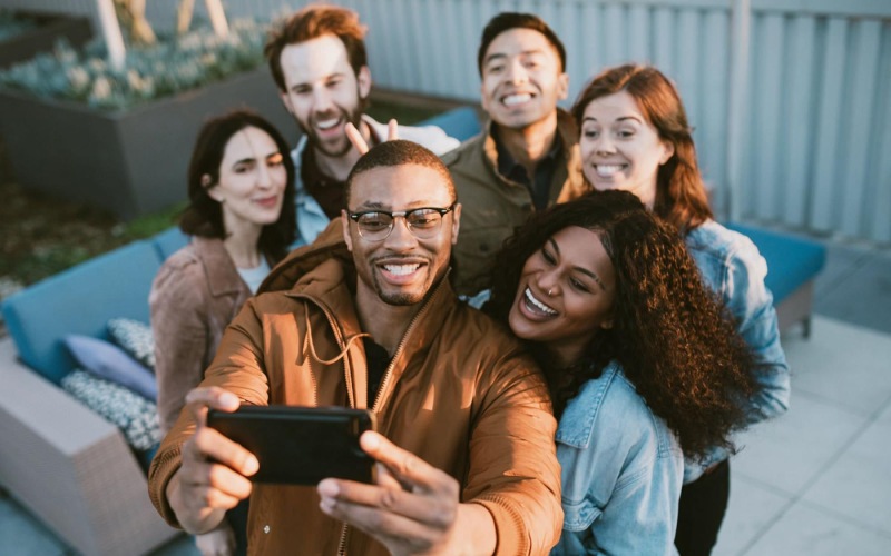 friends take a group selfie outdoors