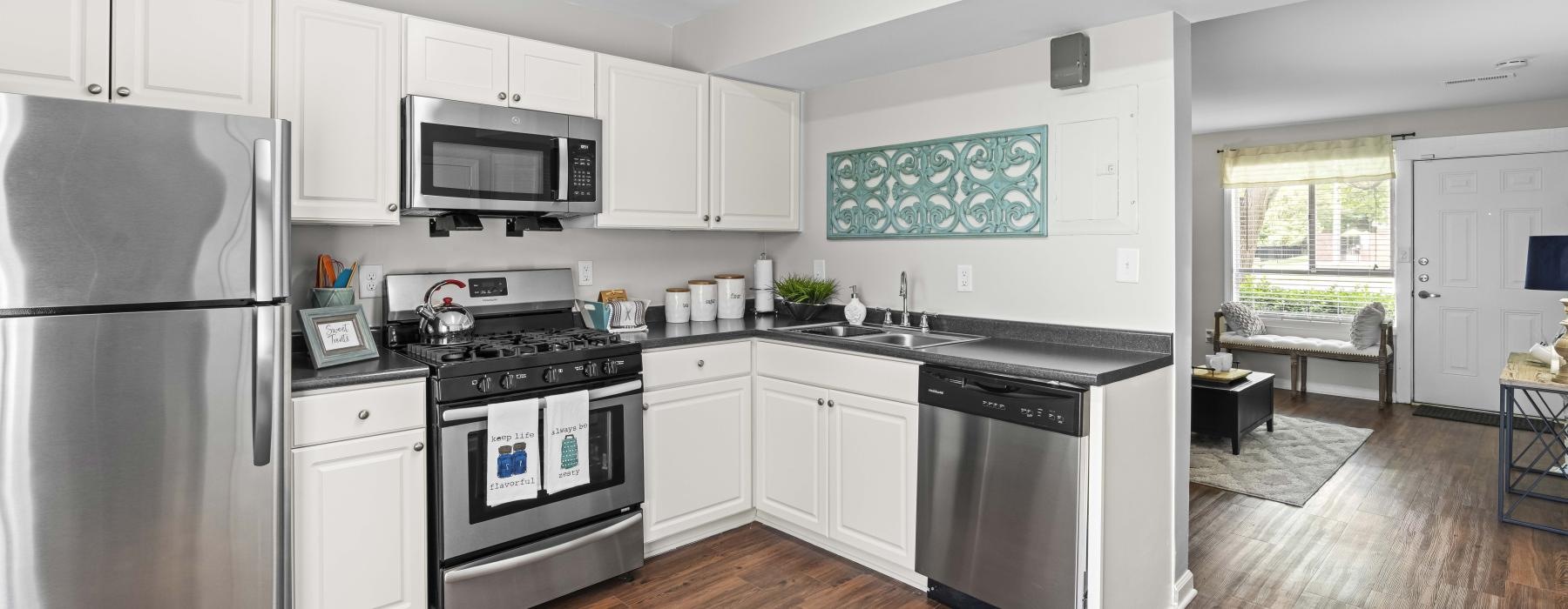 a kitchen with white cabinets