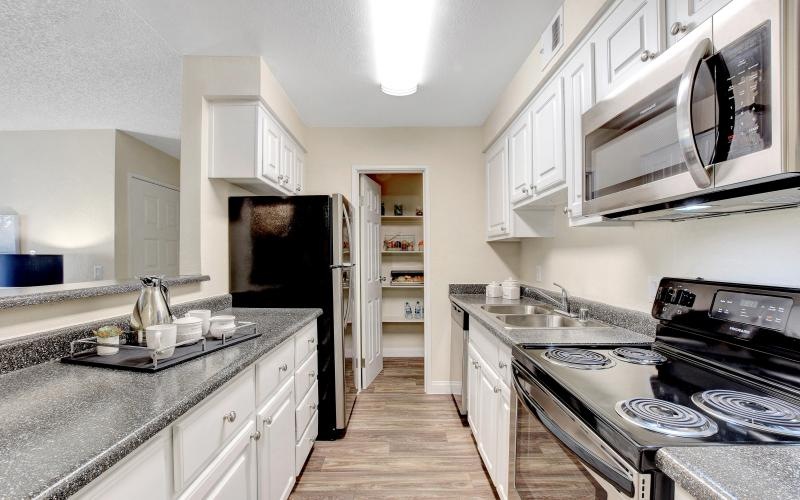a kitchen with white cabinets