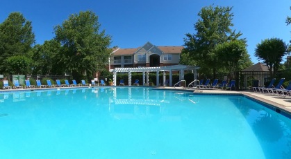 Sparkling swimming pool with lounge seating and umbrellas