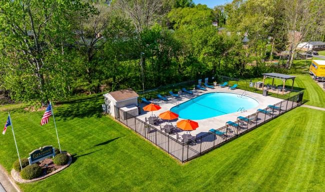 an aerial view of a pool and a park