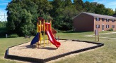 Brightly colored playground in a mulch bed at London Towne