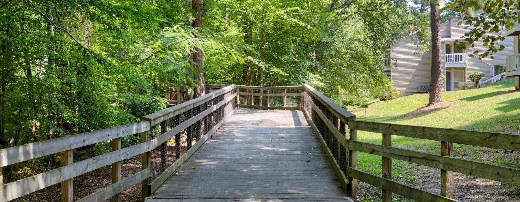 a wooden bridge with a wooden railing