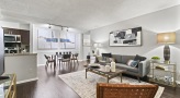 Living room with lots of natural light and dining room