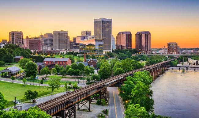 a river with a bridge and buildings in the background