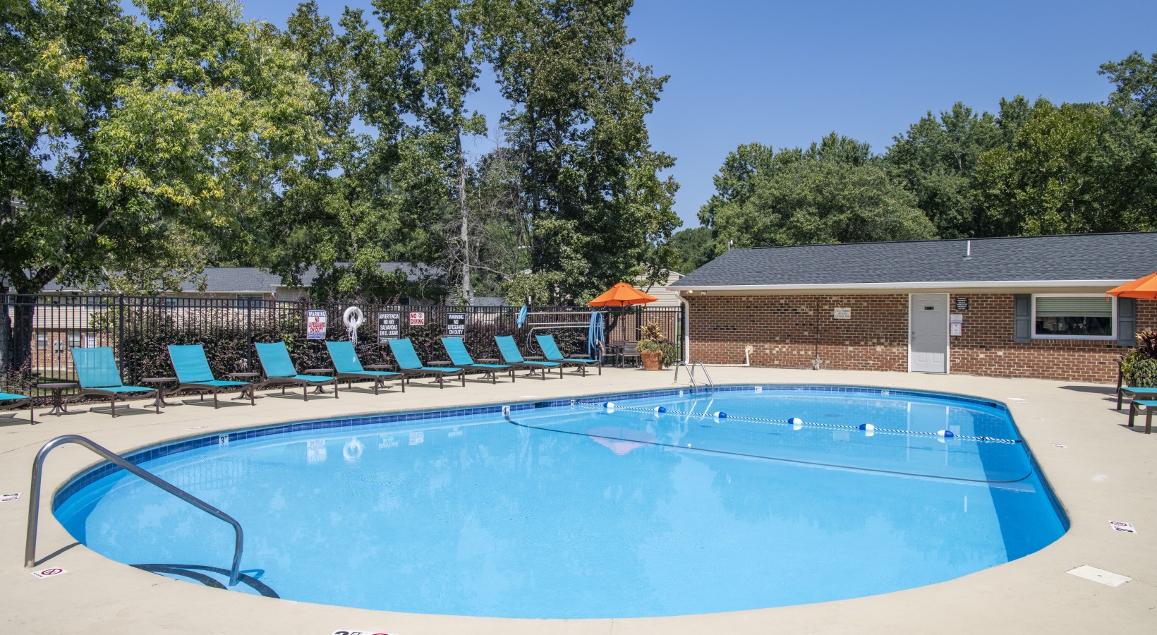 Swimming pool with lounge seating and umbrellas