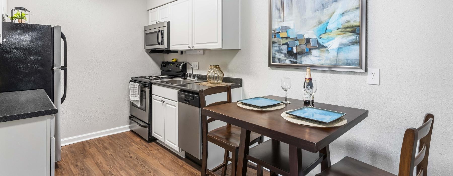a kitchen with a table and chairs