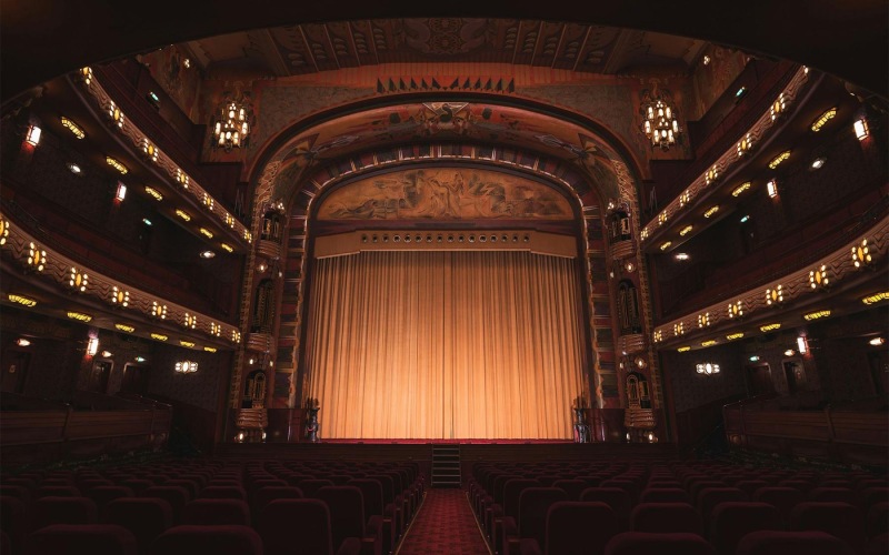 a theater with a stage and chairs