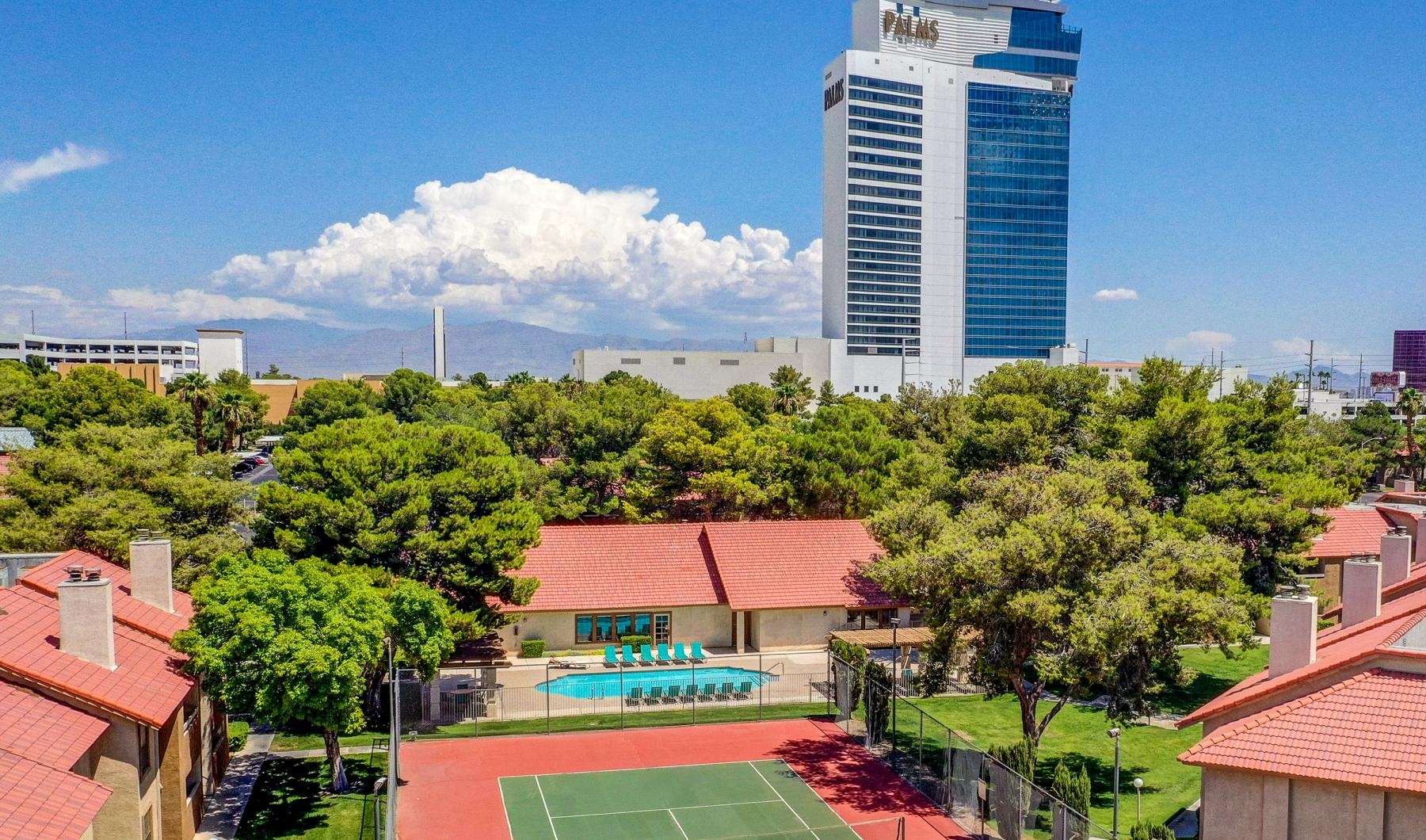 a tennis court in a courtyard surrounded by buildings