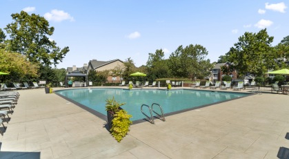 Swimming pool with lounge seating and umbrellas