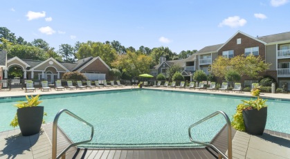 Swimming pool with lounge seating and umbrellas