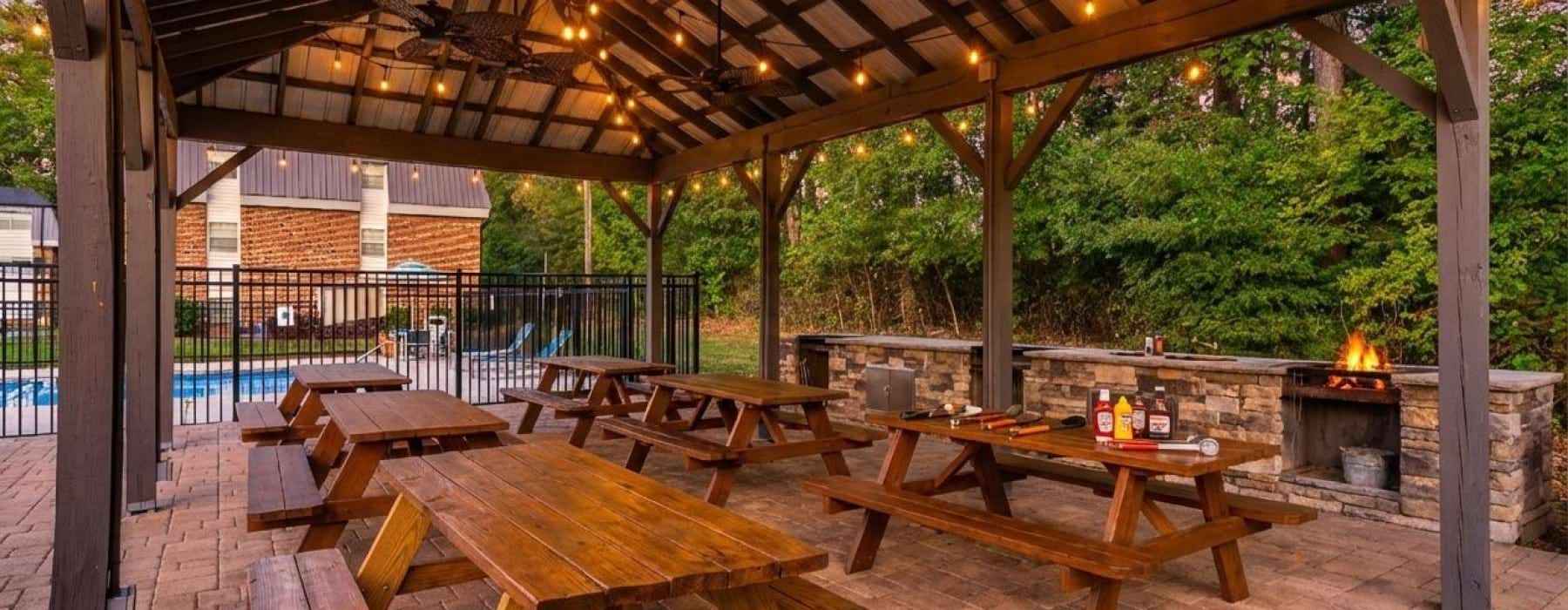 Outdoor grilling area with picnic tables