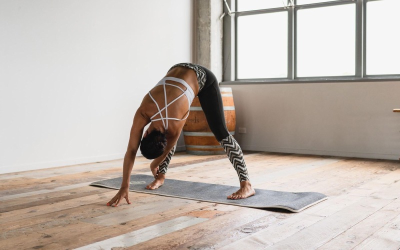 woman doing yoga in sun-filled studio