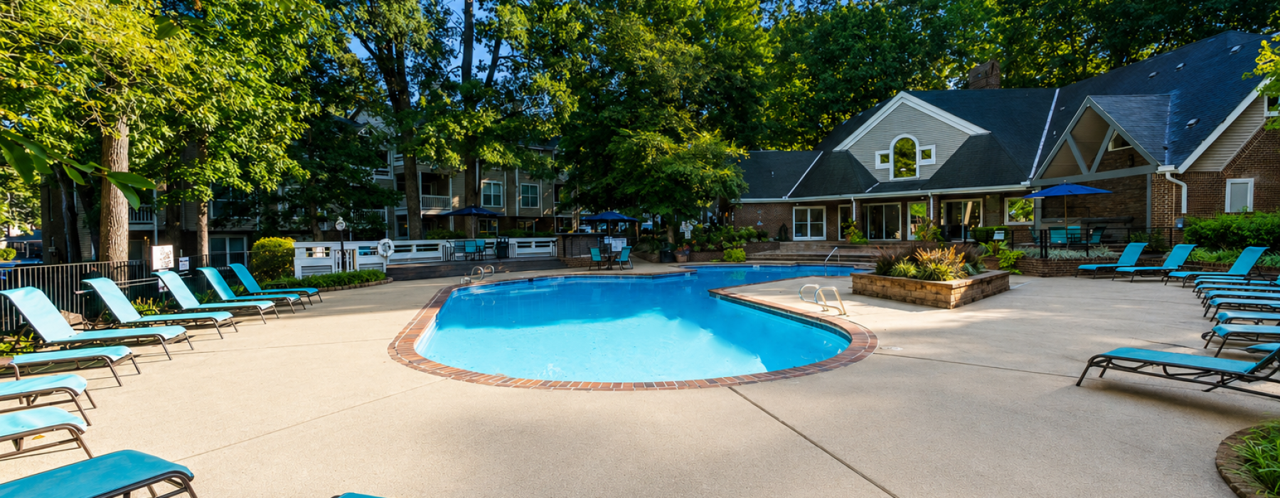 a swimming pool with trees and buildings in the background