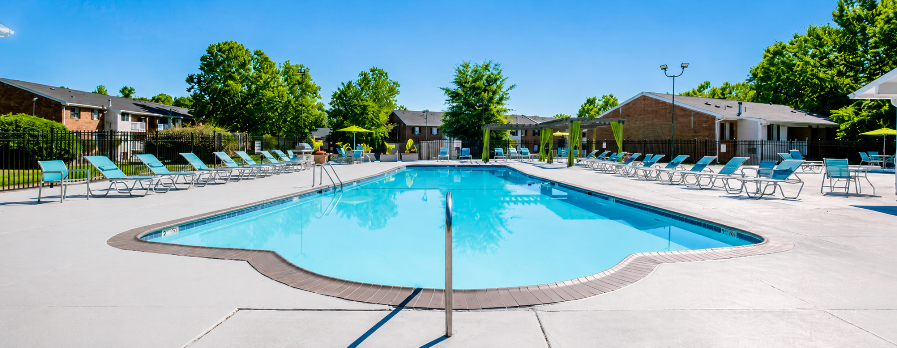 Swimming pool with lounge seating and umbrellas