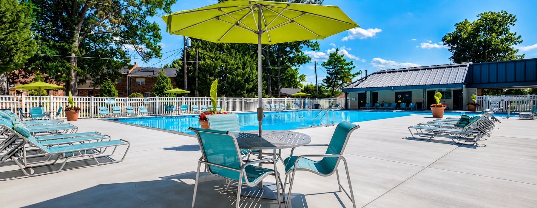 Swimming pool with lounge seating and umbrellas