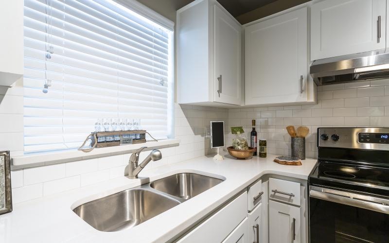 a kitchen with white cabinets