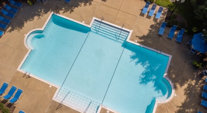 Aerial view of  swimming pool with lounge seating and umbrellas
