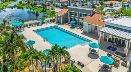 Salt-water pool with lounge seating and umbrellas