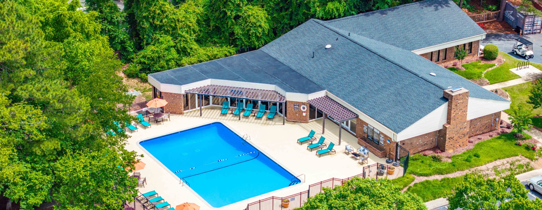 Swimming pool with lounge seating and umbrellas