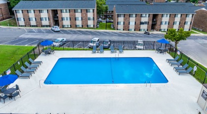 Upper swimming pool surrounded by lounge chairs