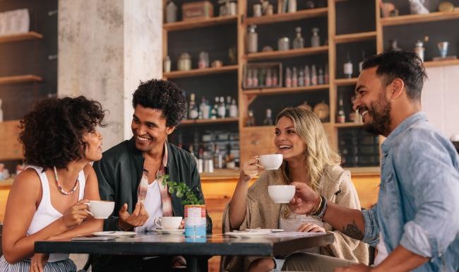 a group of people sitting around a restaurant table