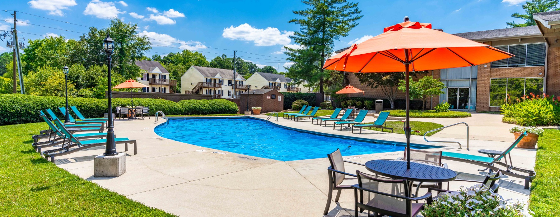 Swimming pool with lounge seating and umbrellas