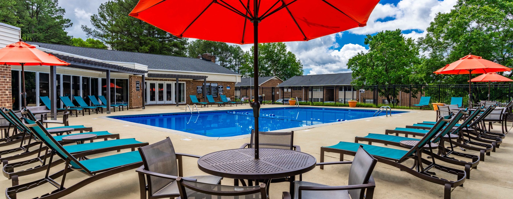 Swimming pool with lounge seating and umbrellas